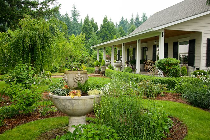 Garden vignette with fountain, lawn and layered planting