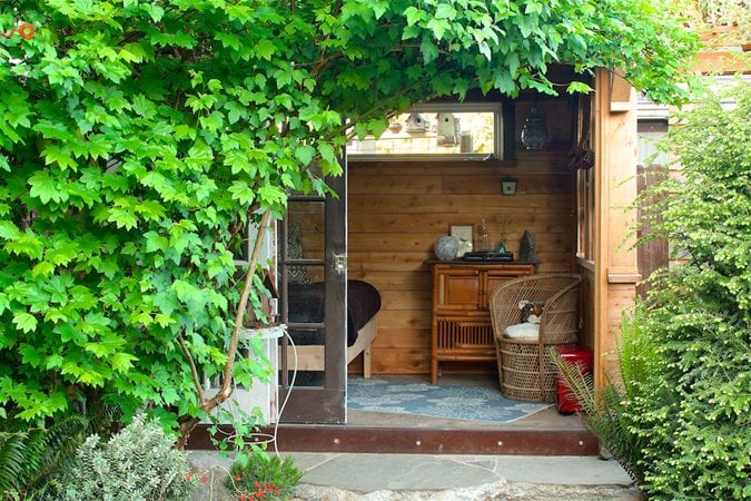 Corner garden retreat with vines and daybed